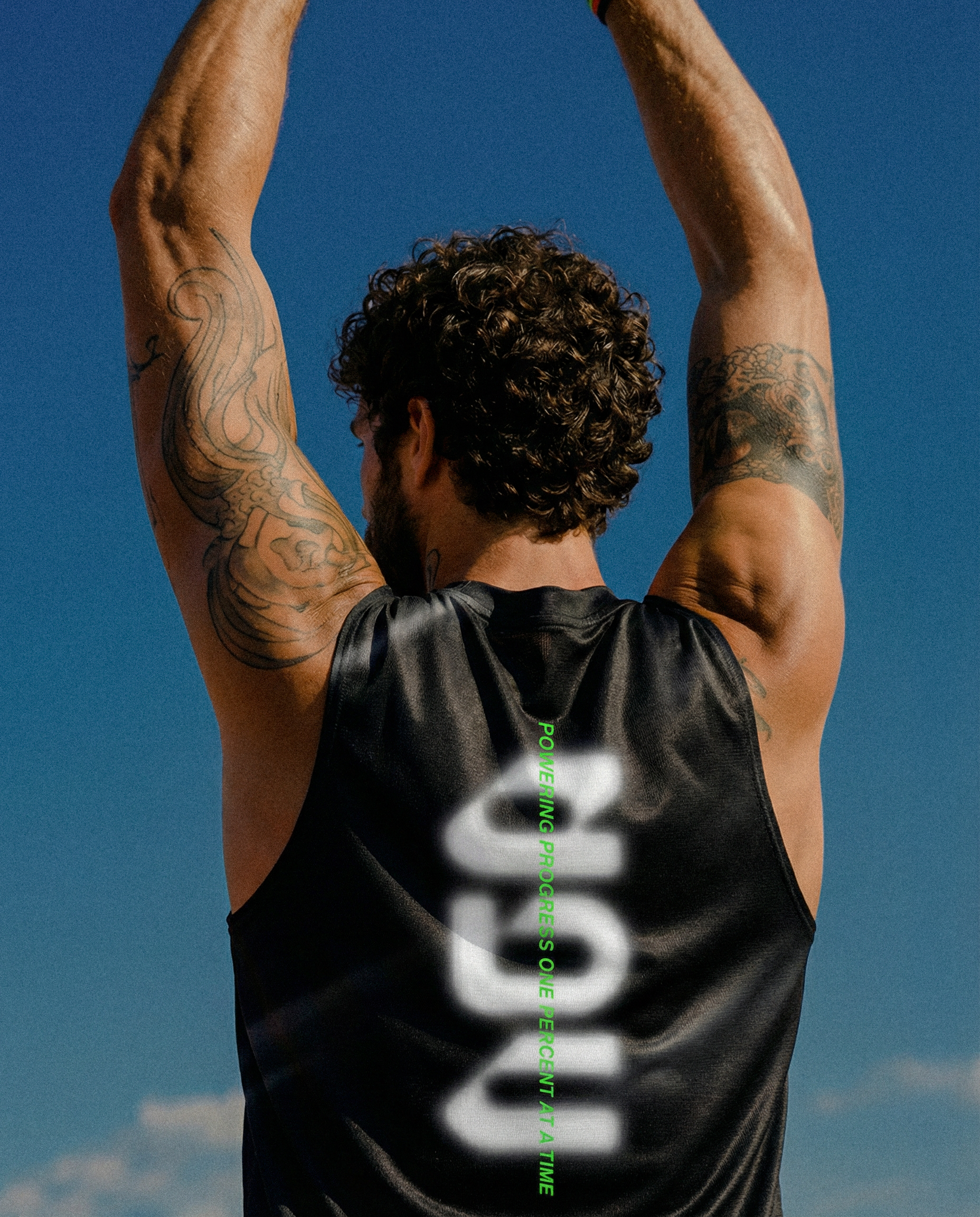 Back view of an athlete stretching in the printed Everyday Better Club vest